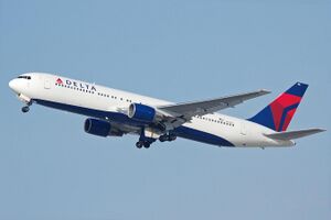 A side/underneath view of a Boeing 767-300 in Delta Air Lines' white, blue, and red color during climbout. The main undercarriage doors are retracting.