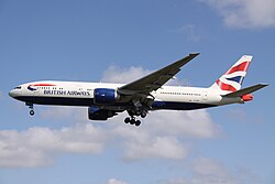 Aircraft landing approach. Side view of twin-engine jet in flight with flaps and landing gear extended.