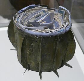 Color photograph of a hollow metal sphere filled with mail.