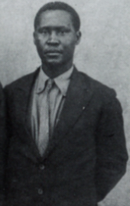Black and white photo from the late 1920s featuring Albert Luthuli, elegantly dressed in a suit.