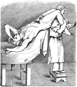subject is lying on their back with legs raised and knees over another person's shoulders