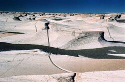 Photo of white wave-like rocks