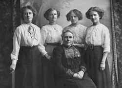 Monochrome photograph of Joseph Hubert Priestley's mother, Henrietta, and four sisters, Edith, Doris, Joyce, and Olive. His mother is seated and his sisters are shown standing
