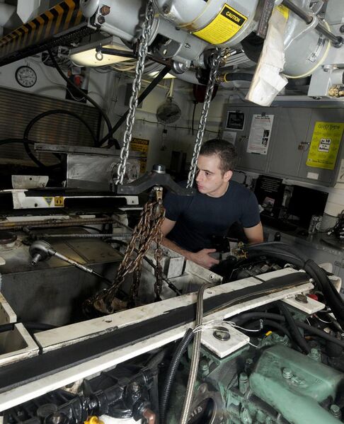 File:US Navy 110929-N-VA840-012 Aviation Structural Mechanic Airman David L. Watson hoists engine parts from a tow tractor aboard the aircraft carrier U.jpg