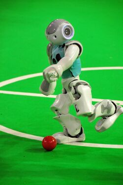 A robot goes for the ball and competes in Robocup.