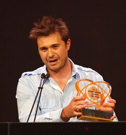 Andy Schatz holding and accepting the "Excellence in Design" award at the 2010 Independent Games Festival