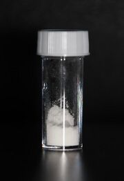 White powder in a stoppered glass vial