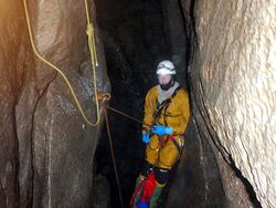 A caver descending Spout Pitch in Swinsto Hole.jpg