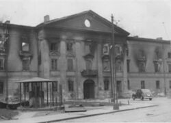 A black-and-white photo of a partially destroyed building of the Wołyń Caserns (commonly known as Gęsiówka), taken during the Warsaw Ghetto Uprising.