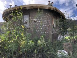 The 'Y Hwb' earthen round house, built using cob and ecobricks by Incredible Edible Porthmadog, North Wales, UK.jpg