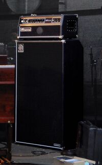 A large bass speaker cabinet with an amplifier unit sitting on top of it.