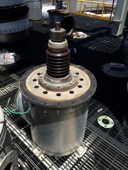Insulator assembly with housing and high voltage bus removed for maintenance and inspection. Insulators are typically used to hold up the electrode fields between the grounded collection plates.