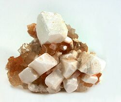 leonite as white pseudomorphs after sharp freestanding picromerite crystals sizes to 2 cm, perched on a matrix of crystallized halite. 5.5 × 4.7 × 3.4 cm
