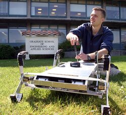 US Navy 060427-N-1825C-001 Combat Systems Sciences and Technology Program Naval Postgraduate student Ensign Tom Dunbar, works with an autonomous robot originally designed to maneuver in agricultural settings.jpg