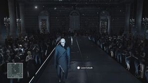 A screenshot of the game, showing Agent 47 disguised as a fashion model, walking down a catwalk surrounded by an audience