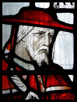 A stained glass portrait of Cardinal John Morton in red clothing.