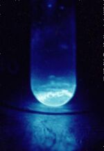 Quartz vial (9 mm diameter) containing ~300 micrograms of solid 253Es. The illumination produced is a result of the intense radiation from 253Es.