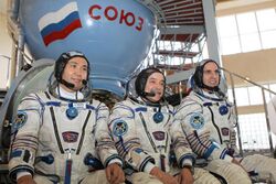 Expedition 36 backup crew members in front of the Soyuz TMA spacecraft mock-up in Star City, Russia.jpg