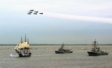 Photo of Constitution under sail with two escorts as navy jets fly overhead