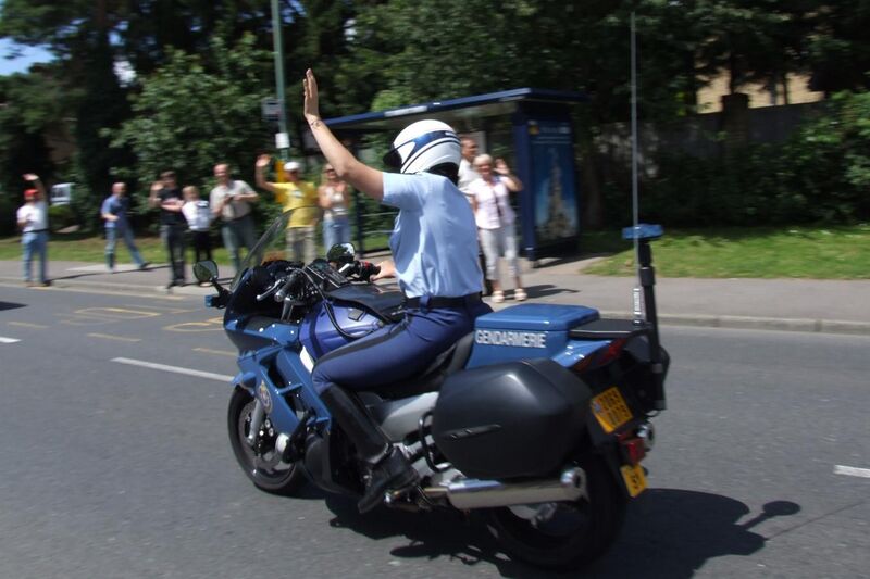 File:Gendarmerie motor officer raising arm in traffic.jpg