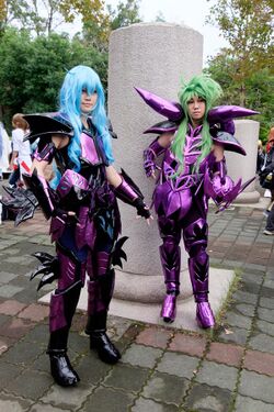 Two people in disguise, wearing sophisticated purple armor and green and blue wigs.