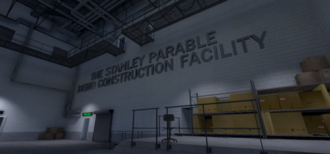 A storage facility with grey floors and off-white walls. Catwalks are suspended above the player, and there are some boxes stacked over to the right. On the wall in block letters is the phrase "The Stanley Parable Demo Construction Facility".