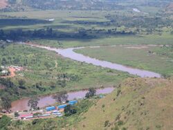 Photograph of confluence of the Kagera and the Ruvubu, with the Rwanda-Tanzania border post in foreground, taken from a nearby hilltop