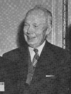 A candid photograph of a man wearing a suit