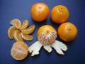 Clementines whole, peeled, half and sectioned.jpg