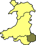 A map of Wales in yellow with a small area in green (about 5%) at the bottom right (south east)