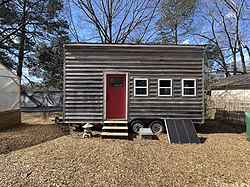 This tiny house on wheels provides a good example of more sustainable shelters. Built from locally produced cypress wood, this tiny house on wheels gives students a sense of what a living system integrated into solar power, rainwater collection, and sustainable utilities looks like.