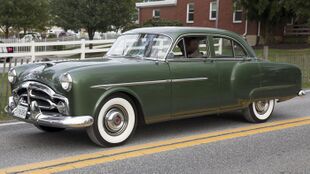 1951 Packard 200 Deluxe 4-door Sedan 2401-2462, front left (Hershey 2019).jpg