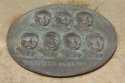 Circular plaque with the faces of the seven astronauts