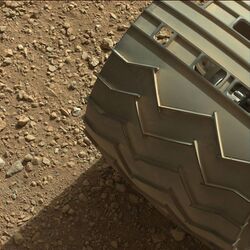 Martian gravel beneath one of the wheels of the Curiosity rover.jpg
