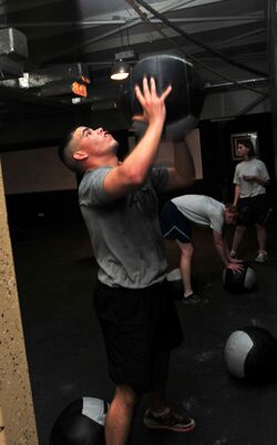Soldier tosses a medicine ball while working out DVIDS462753.jpg