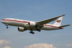 Aircraft landing approach. Side view of twin-engine jet in flight with flaps and landing gear extended.