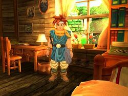 Horizontal rectangular video game screenshot that is a digital representation of a room in a house. A character with red spiked hair stands in the center of the image.