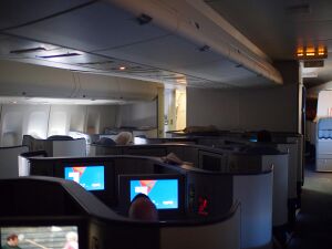 Aircraft cabin with first class seats.