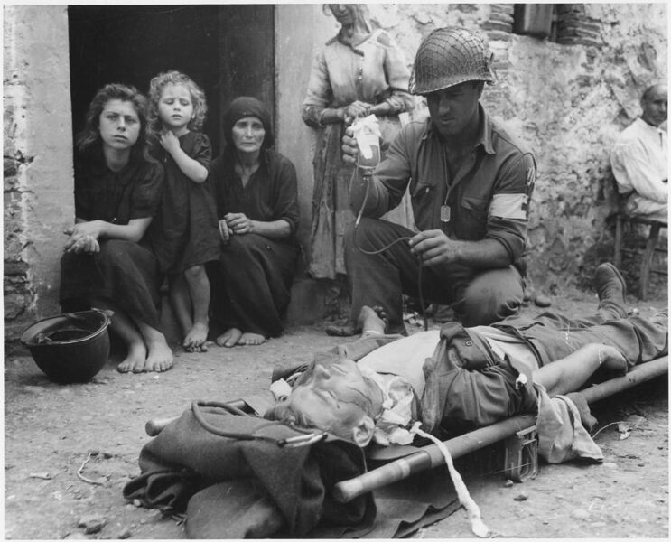 File:Private Roy W. Humphrey of Toledo, Ohio is being given blood plasma after he was wounded by shrapnel in Sicily on 8-9-43 - NARA - 197268.jpg