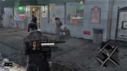 The player character walking through an urban environment, using his smartphone to scan the area. The heads-up display elements are visible onscreen.