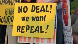 A black-on-yellow sign saying "No deal! We want repeal!"