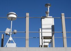 Air pollution monitoring station in Reno, Nevada showing air inlets and sensor.