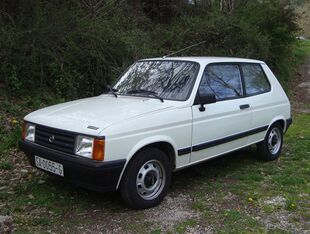 A small three-door passenger car.