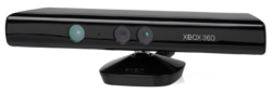 A long, black plastic tube with a stand on its bottom and sensors arrayed along its front. The Xbox 360 brand is displayed next to the sensors.