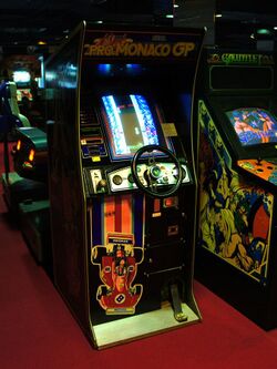 An arcade cabinet with a wheel and a pedal