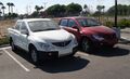 Two Phoenix Motorcars in parking lot.jpg