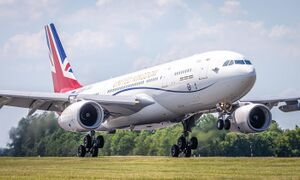 A gloss white painted Airbus A330 with a red, white and blue 'union jack' flag on its vertical tail fin, operated by the Royal Air Force, which has been modified for military and VIP use, is about to land RAF Brize Norton in Oxfordshire.