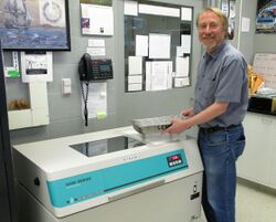 Richard Lenski with Long-Term Flasks and Incubator on May 26, 2016.jpg