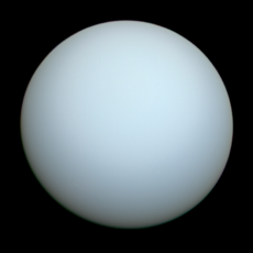 A whitish blue spherical planet against the black background of space