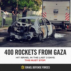 Poster showing a burned-out car on a street in Israel. Caption: "400 rockets from Gaza hit Israel in the last 3 days. This must stop. Israel Defense Forces"